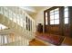 Elegant foyer with a grand staircase, hardwood floors, and a stylish entryway rug leading to a beautifully designed interior space at 2213 Weybridge Dr, Raleigh, NC 27615