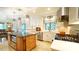 Bright kitchen with stainless steel appliances, island, and white cabinets at 2213 Weybridge Dr, Raleigh, NC 27615