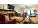 Inviting living room featuring a stone fireplace, TV, ceiling fan and comfortable seating at 2213 Weybridge Dr, Raleigh, NC 27615