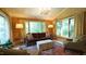 Sunlit living room with neutral furniture, large windows, and decorative lighting fixtures at 2213 Weybridge Dr, Raleigh, NC 27615