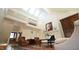Bright living room featuring vaulted ceilings, skylights, stone fireplace, and balcony overlooking the space at 2213 Weybridge Dr, Raleigh, NC 27615