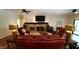 Spacious living room featuring a stone fireplace, TV, ceiling fan, and comfortable seating at 2213 Weybridge Dr, Raleigh, NC 27615