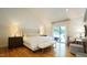 A primary bedroom with lots of light, hardwood floors, and access to a balcony at 2213 Weybridge Dr, Raleigh, NC 27615