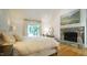 Bedroom featuring hardwood floors, decorative fireplace, and natural light at 2213 Weybridge Dr, Raleigh, NC 27615