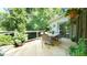 Wood deck featuring an outdoor dining table and surrounding landscape at 2213 Weybridge Dr, Raleigh, NC 27615