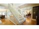 Bright staircase features white railings, carpeted steps, and hardwood flooring at 2213 Weybridge Dr, Raleigh, NC 27615