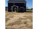Exterior view of the backyard featuring a navy blue home with white trim and a covered back porch at 23 Surles Landing Way, Benson, NC 27504