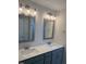 Bathroom featuring double sinks with modern fixtures, framed mirrors, and ample countertop space at 23 Surles Landing Way, Benson, NC 27504