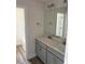 Bathroom featuring a double vanity, modern lighting fixtures, and a large mirror at 23 Surles Landing Way, Benson, NC 27504