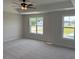 Spacious bedroom with a ceiling fan and two windows bringing in plenty of natural light at 23 Surles Landing Way, Benson, NC 27504