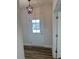 View of the light-filled entryway with a modern black pendant light and a front door with glass panels at 23 Surles Landing Way, Benson, NC 27504