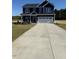 Charming navy two-story home with a spacious driveway and well-maintained front lawn at 23 Surles Landing Way, Benson, NC 27504