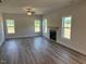 Spacious living room with a ceiling fan, fireplace, and multiple windows for ample natural light at 23 Surles Landing Way, Benson, NC 27504
