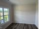 Bright room featuring a double window providing natural light and wood-look flooring at 23 Surles Landing Way, Benson, NC 27504