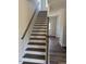 White and wood staircase featuring brown treads and a white handrail at 23 Surles Landing Way, Benson, NC 27504