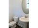 Bathroom features a modern sink with oval mirror and commode at 48 Surles Landing Way, Benson, NC 27504