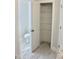 Half bathroom with toilet and shelving unit in separate room and tile flooring at 48 Surles Landing Way, Benson, NC 27504