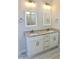 Bathroom with double sink vanity, granite countertop, tile floors and framed mirrors at 48 Surles Landing Way, Benson, NC 27504