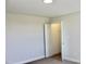 View of a bedroom with neutral colored walls and carpet, and a doorway to a closet at 48 Surles Landing Way, Benson, NC 27504