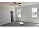 Spacious bedroom with plush carpet, crown moulding, ceiling fan and two windows offering natural light at 48 Surles Landing Way, Benson, NC 27504
