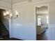 Dining room has a modern chandelier, dark wood floors, and view of the kitchen at 48 Surles Landing Way, Benson, NC 27504