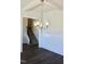 Dining room features a modern chandelier, dark wood floors, and white wainscoting at 48 Surles Landing Way, Benson, NC 27504