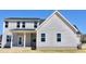Rear exterior elevation of home featuring many windows, porch and vinyl siding at 48 Surles Landing Way, Benson, NC 27504