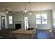 Kitchen island with a stainless steel sink, granite countertops, and view of living room at 48 Surles Landing Way, Benson, NC 27504