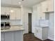 Kitchen features white cabinets, granite countertops, stainless steel appliances, island, and subway tile at 48 Surles Landing Way, Benson, NC 27504