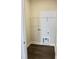 Bright laundry room with dark wood-look flooring and wire rack shelving for ample storage at 48 Surles Landing Way, Benson, NC 27504