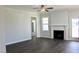 Living room with dark wood floors, white fireplace and trim, and a ceiling fan at 48 Surles Landing Way, Benson, NC 27504