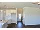 Open-concept living room and kitchen with white cabinets, granite countertops, and stainless steel sink at 48 Surles Landing Way, Benson, NC 27504