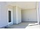Covered patio with concrete flooring and a view of the backyard through a glass door at 48 Surles Landing Way, Benson, NC 27504