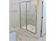 Shower with a glass door enclosure and decorative gray tiling at 48 Surles Landing Way, Benson, NC 27504