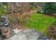 Aerial view of a large backyard featuring a concrete patio, brick patio, and lush green lawn at 5205 Rembert Dr, Raleigh, NC 27612