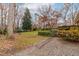 A spacious back yard with a playset sits beside a beautiful brick home at 5205 Rembert Dr, Raleigh, NC 27612
