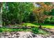 Lush backyard featuring a playhouse, mature trees, and a large grassy area for recreation at 5205 Rembert Dr, Raleigh, NC 27612