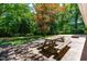 Relaxing backyard with a picnic table, fire pit, and lush greenery, perfect for outdoor enjoyment at 5205 Rembert Dr, Raleigh, NC 27612