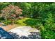 Expansive backyard with lush lawn, mature trees, and a patio, ideal for outdoor living at 5205 Rembert Dr, Raleigh, NC 27612