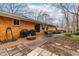 A brick patio features two grills, a fire pit, and an outdoor dining table and chairs at 5205 Rembert Dr, Raleigh, NC 27612