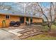 A large brick patio features two grills, a fire pit, and an outdoor dining table at 5205 Rembert Dr, Raleigh, NC 27612