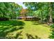 Lush backyard with a play structure and large lawn at 5205 Rembert Dr, Raleigh, NC 27612