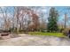 Expansive backyard with a patio area, mature trees, and ample space for outdoor activities and relaxation at 5205 Rembert Dr, Raleigh, NC 27612
