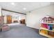 Finished basement showcases a brick fireplace, carpeted flooring, and a bright window, perfect for a home office or playroom at 5205 Rembert Dr, Raleigh, NC 27612