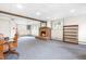 Basement area featuring a brick fireplace, carpeted floor, and windows for natural light; a versatile living space at 5205 Rembert Dr, Raleigh, NC 27612