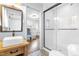 Modern bathroom with a wood vanity, glass enclosed shower, and stylish tile flooring at 5205 Rembert Dr, Raleigh, NC 27612