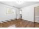 Neutral bedroom with hardwood floors, closet, and a window for natural light at 5205 Rembert Dr, Raleigh, NC 27612
