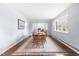 Traditional dining room with wood floors and a patterned rug, illuminated by natural light from a window at 5205 Rembert Dr, Raleigh, NC 27612