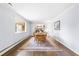 Dining area with a table, six chairs, large window, hardwood floors, and a colorful area rug at 5205 Rembert Dr, Raleigh, NC 27612