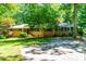 Traditional brick home with mature trees and a spacious front yard, perfect for outdoor activities at 5205 Rembert Dr, Raleigh, NC 27612